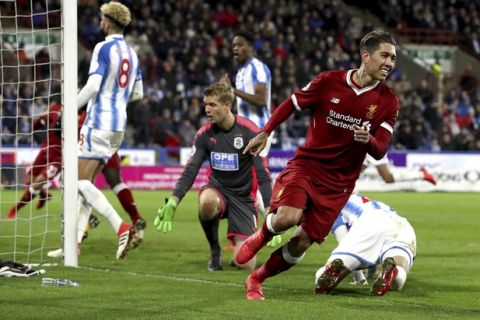 Liverpool's Roberto Firmino celebrates scoring his side's second goal of the game against Huddersfield Town during their English Premier League soccer match at the John Smith's Stadium in Huddersfield, England, Tuesday Jan. 30, 2018. (Martin Rickett/PA via AP)