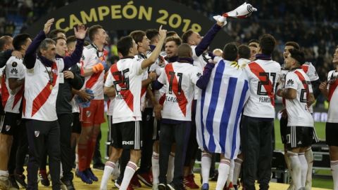 Argentina's River Plate players celebrate their victory over Argentina's Boca Juniors in the Copa Libertadores final soccer match at the Santiago Bernabeu stadium in Madrid, Spain, Monday, Dec. 10, 2018. (AP Photo/Thanassis Stavrakis)
