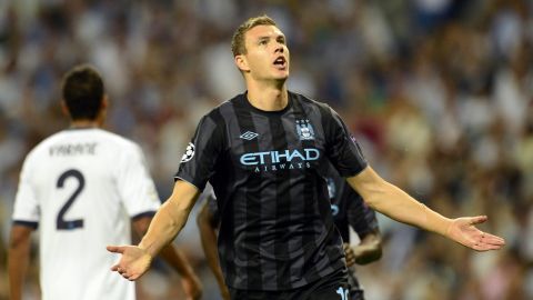 Manchester City's Bosnian forward Edin Dzeko celebrates after scoring a goal during the Champions League Group D football match Real Madrid vs Mancherter City at Santiago Bernabeu stadium in Madrid on September 18, 2012.  AFP PHOTO / JAVIER SORIANO        (Photo credit should read JAVIER SORIANO/AFP/GettyImages)