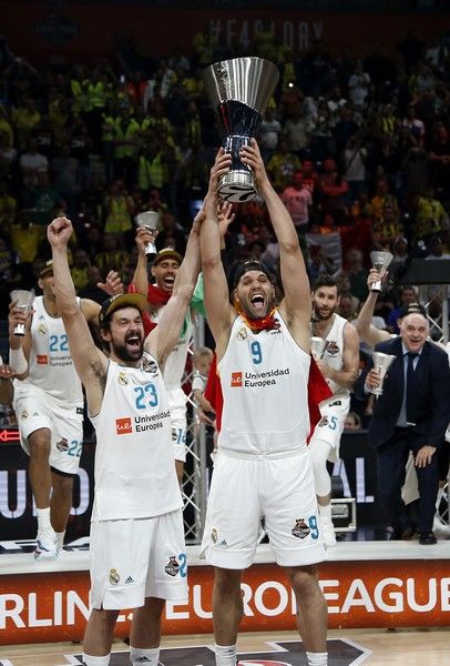 Real Madrid's Felipe Reyes, right, and Sergio Llull lift the trophy as the team celebrates their 85-80 win in the Final Four Euroleague final basketball match between Real Madrid and Fenerbahce Istanbul in Belgrade, Serbia, Sunday, May 20, 2018. (AP Photo/Darko Vojinovic)
