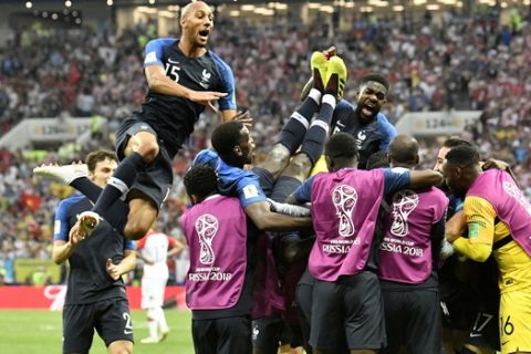 French players celebrate after Kylian Mbappe scored his side's fourth goal during the final match between France and Croatia at the 2018 soccer World Cup in the Luzhniki Stadium in Moscow, Russia, Sunday, July 15, 2018. (AP Photo/Martin Meissner)