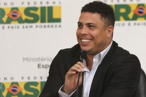 Brazil striker Ronaldo, who is part of Brazil's 2014 World Cup organizing committee, smiles during a joint news conference with committee members, in Brasilia, Brazil, Monday, Jan. 16, 2012. FIFA Secretary-General Jerome Valcke is visiting Brazil this week and meeting with top officials. Valcke has heavily criticized Brazil's preparations for the 2014 World Cup, saying they're behind schedule. But he says FIFA and Brazilian officials are working well together to get the nation prepared to host the event. (AP Photo/Fabio Pozzebom)