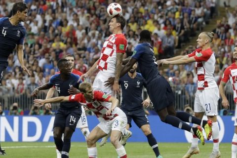 Croatia's Mario Mandzukic, center, scores an own goal during the final match between France and Croatia at the 2018 soccer World Cup in the Luzhniki Stadium in Moscow, Russia, Sunday, July 15, 2018. (AP Photo/Matthias Schrader)