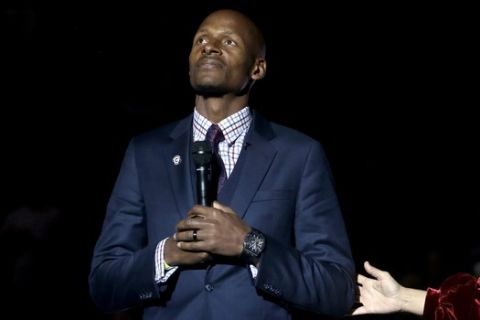 Naismith Memorial Basketball Hall of Famer Ray Allen holds a microphone as his number is retired to the rafters during a halftime ceremony at an NCAA college basketball game between South Florida and Connecticut, Sunday, March 3, 2019, in Storrs, Conn. (AP Photo/Steven Senne)