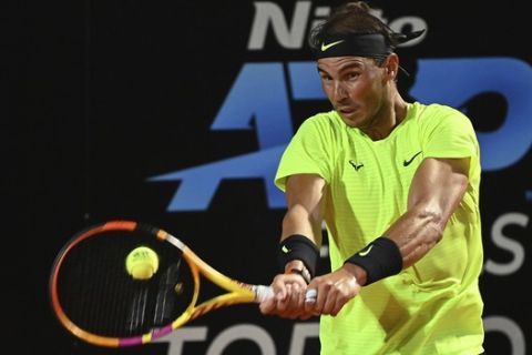 Spain's Rafael Nadal returns the ball to Serbia's Dusan Lajovic during their Italian Open tennis tournament match, in Rome, Friday, Sept. 18, 2020. (Alfredo Falcone/LaPresse via AP)