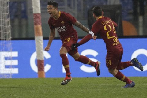 Roma's Justin Kluivert, left, celebrates after scoring during the Italian Serie A soccer match between Roma and Genoa in Rome's Olympic stadium, Sunday, Dec. 16, 2018. (AP Photo/Gregorio Borgia)