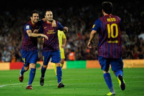 BARCELONA, SPAIN - AUGUST 29:  Lionel Messi of FC Barcelona (R) celebrates with his teammates Cesc Fabregas (L) and Andres Iniesta after scoring his fourth team's goal under a challenge by the goalkeeper Diego Lopez of Villarreal CF during the La Liga match between FC Barcelona and Villarreal CF at Camp Nou on August 29, 2011 in Barcelona, Spain.  (Photo by David Ramos/Getty Images)