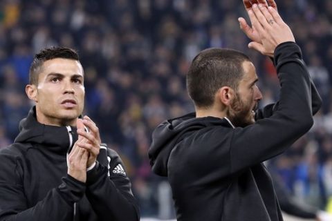 Juventus forward Cristiano Ronaldo, left, and Leonardo Bonucci applaud fans prior to the Champions League group H soccer match between Juventus and Manchester United at the Allianz stadium in Turin, Italy, Wednesday, Nov. 7, 2018. (AP Photo/Antonio Calanni)
