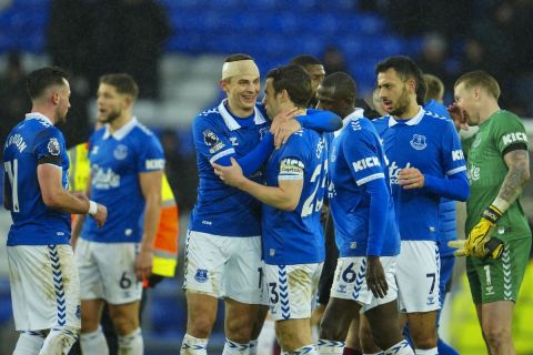 Everton players celebrate at the end of the English Premier League soccer match between Everton and Aston Villa, at Goodison Park stadium in Liverpool, England, Sunday, Jan. 14, 2024. (AP Photo/Jon Super)