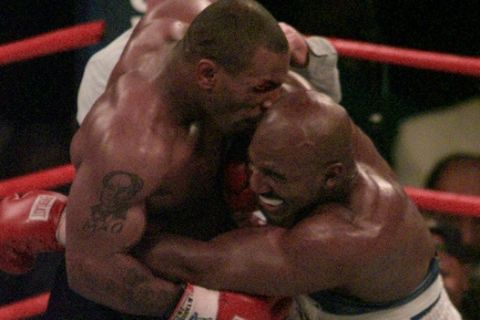 Mike Tyson bites into the ear of Evander Holyfield in the third round of their WBA Heavyweight match Saturday, June 28, 1997, at the MGM Grand in Las Vegas.  (AP Photo/Jack Smith)