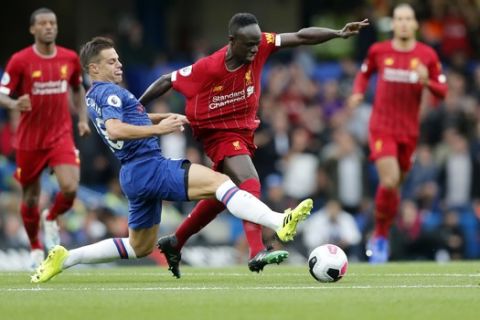 Chelsea's Cesar Azpilicueta, left, challenges Liverpool's Sadio Mane during the British Premier League soccer match between Chelsea and Liverpool, at the Stamford Bridge Stadium, London, Sunday, Sept. 22, 2019. (AP Photo/Frank Augstein)