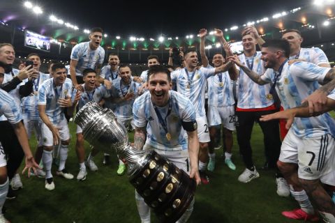 Argentina's Lionel Messi celebrates with the trophy after beating Brazil 1-0  in the Copa America final soccer match at the Maracana stadium in Rio de Janeiro, Brazil, Saturday, July 10, 2021. (AP Photo/Bruna Prado)