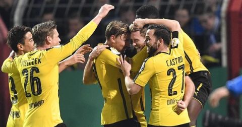 Dortmund's Andre Schuerrle is celebrated by his team after scoring his side's second goal during the German Soccer Cup quarterfinal match between SF Lotte and Borussia Dortmund in Osnabrueck, Germany, Tuesday, March 14, 2017. (AP Photo/Martin Meissner)