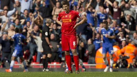 Liverpool's Steven Gerrard watches as Chelsea celebrate their second goal during their English Premier League soccer match at Anfield Stadium, Liverpool, England, Sunday April 27, 2014. Chelsea won the game 2-0. (AP Photo/Jon Super)