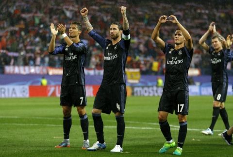 Real Madrid's Cristiano Ronaldo, left, Sergio Ramos, center, and Lucas Vazquez wave to their fans after the Champions League semifinal second leg soccer match between Atletico Madrid and Real Madrid at the Vicente Calderon stadium in Madrid, Spain, Wednesday, May 10, 2017. (AP Photo/Francisco Seco)