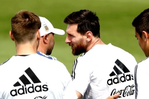Lionel Messi is congratulated by coach Jorge Sampaoli on the day of his birthday during a training session of Argentina at the 2018 soccer World Cup in Bronnitsy, Russia, Sunday, June 24, 2018. (AP Photo/Ricardo Mazalan)