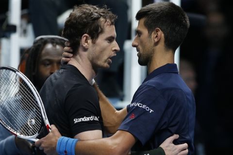 Andy Murray of Britain, left, speaks to Novak Djokovic of Serbia after winning the ATP World Tour Finals singles final tennis match at the O2 Arena in London, Sunday, Nov. 20, 2016. (AP Photo/Alastair Grant)