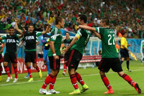 RECIFE, BRAZIL - JUNE 23:  Rafael Marquez of Mexico (center) celebrates scoring his team's first goal during the 2014 FIFA World Cup Brazil Group A match between Croatia and Mexico at Arena Pernambuco on June 23, 2014 in Recife, Brazil.  (Photo by Robert Cianflone/Getty Images)