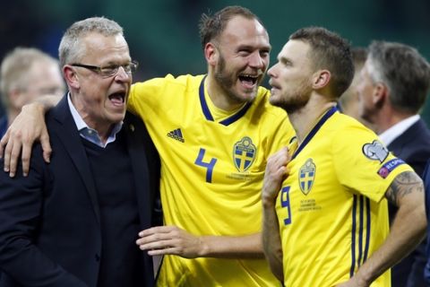 Sweden coach Janne Andersson celebrates with Andreas Granqvist and Marcus Berg, right, at the end of the World Cup qualifying play-off second leg soccer match between Italy and Sweden, at the Milan San Siro stadium, Italy, Monday, Nov. 13, 2017. Four-time champion Italy has failed to qualify for World Cup; Sweden advances with 1-0 aggregate win in playoff. (AP Photo/Antonio Calanni)