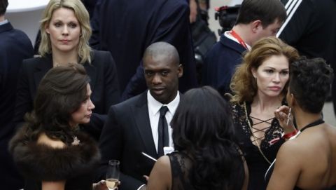 Former Dutch soccer international Clarence Seedorf, center, arrives for the 2018 soccer World Cup draw in the Kremlin in Moscow, Friday Dec. 1, 2017. (AP Photo/Pavel Golovkin)