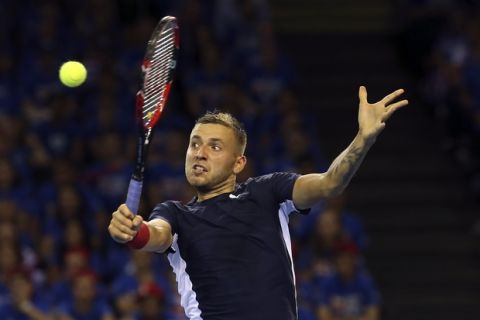 Britain's Dan Evans plays a return to Australia's Bernard Tomic during the semifinal tennis matches of the Davis Cup in Glasgow, Friday Sept. 18, 2015. (AP Photo/Scott Heppell)