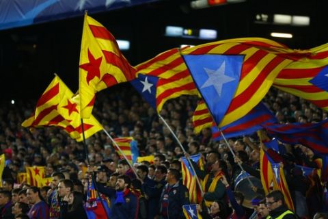 Barcelona fans wave Estelada independence flags during a Champions League quarter-final, first leg soccer match between FC Barcelona and Atletico Madrid at the Camp Nou stadium in Barcelona, Spain, Tuesday April 5, 2016. (AP Photo/Manu Fernandez)