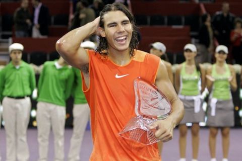 Rafael Nadal from Spain smiles as he holds his trophy after his win over Ivan Ljubicic from Croatia during the price giving ceremony of the ATP Masters Series Madrid tennis tournament in Madrid, Sunday, Oct. 23, 2005. Nadal won the final in 5 sets, 3-6, 2-6, 6-3, 6-4 and 7-6 (3). (AP Photo/Bernat Armangue)
