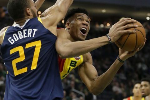Milwaukee Bucks' Giannis Antetokounmpo, front right, drives against Utah Jazz's Rudy Gobert (27) during the first half of an NBA basketball game Monday, Jan. 7, 2019, in Milwaukee. (AP Photo/Aaron Gash)