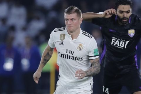 Real Madrid's midfielder Toni Kroos and Emirates's Al Ain Hussein Elshahat fight for the ball during the Club World Cup final soccer match between Real Madrid and Al Ain at Zayed Sport City in Abu Dhabi, United Arab Emirates, Saturday, Dec. 22, 2018. (AP Photo/Hassan Ammar