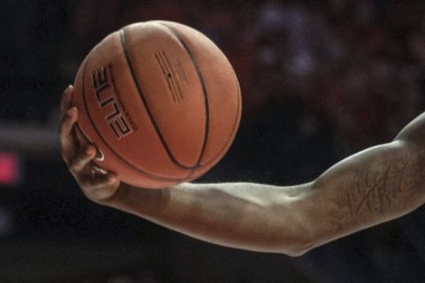 Illinois' DeMonte Williams (20) passes the ball under the basket around Maryland defender Donta Scott during the first half of an NCAA college basketball game Friday, Feb. 7, 2020, in Champaign, Ill. (AP Photo/Holly Hart)