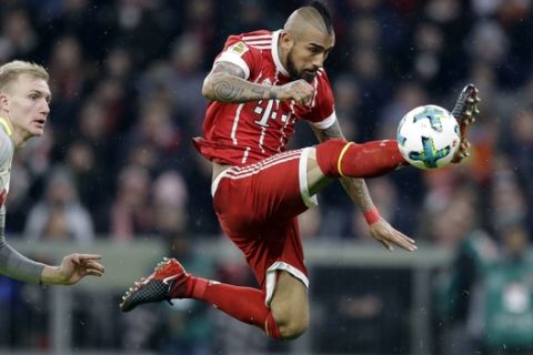 Bayern's Arturo Vidal, right, and Cologne's Frederik Soerensen challenge for the ball during the German Soccer Bundesliga match between FC Bayern Munich and 1.FC Koeln in Munich, Germany, Wednesday, Dec. 13, 2017. (AP Photo/Matthias Schrader)