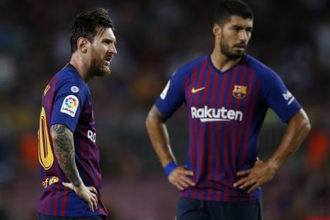 FC Barcelona's Lionel Messi, left, and Luis Suarez pause during the Spanish La Liga soccer match between FC Barcelona and Alaves at the Camp Nou stadium in Barcelona, Spain, Saturday, Aug. 18, 2018. (AP Photo/Manu Fernandez)
