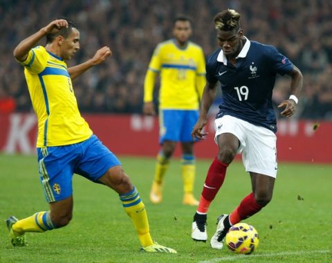 France's midfielder Paul Pogba, right, challenges for the ball with Sweden's forward Nabil Bahoui, during an international friendly soccer match between France and Sweden, at the Velodrome Stadium, in Marseille, southern France, Tuesday, Nov. 18, 2014. (AP Photo/Claude Paris)