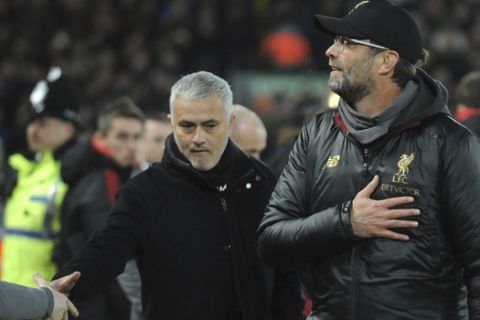 Liverpool manager Juergen Klopp, right, and Manchester United manager Jose Mourinho seen prior to the English Premier League soccer match between Liverpool and Manchester United at Anfield in Liverpool, England, Sunday, Dec. 16, 2018. (AP Photo/Rui Vieira)