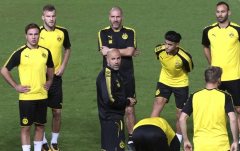 Dortmund head coach Peter Bosz gives instructions to his players during a training session at GSP stadium, in Nicosia, Cyprus, on Monday, Oct. 16, 2017. Dortmund will play against APOEL Nicosia in a Champions League Group H soccer match on Wednesday. (AP Photo/Petros Karadjias)