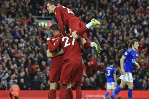 Liverpool players celebrate Liverpool's James Milner wining goal during English Premier League soccer match between Liverpool and Leicester City in Anfield stadium in Liverpool, England, Saturday, Oct. 5, 2019. (AP Photo/Jon Super)