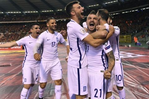 Greece's Kostas Stafylidis, center, celebrates with team mates after Greece scored a first match goal during the Euro 2018 Group H qualifying match between Belgium and Greece at the King Baudouin stadium in Brussels on Saturday, March 25, 2017. (AP Photo/Geert Vanden Wijngaert)