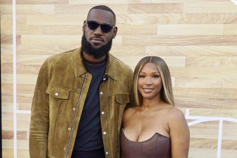 LeBron James, left, a producer of the Netflix film "Hustle," poses with his wife Savannah at the premiere of the film, Wednesday, June 1, 2022, at the Regency Village Theatre in Los Angeles. (AP Photo/Chris Pizzello)