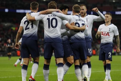Tottenham's Harry Kane, second left, celebrates with his teammates after scoring his side's opening goal during the English Premier League soccer match between Tottenham Hotspur and Southampton at Wembley Stadium in London, Wednesday, Dec. 5, 2018. (AP Photo/Frank Augstein)