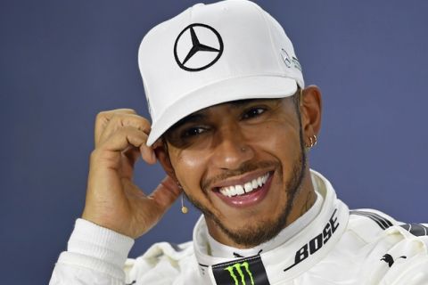 Mercedes driver Lewis Hamilton of Britain smiles at a press conference after taking pole position for the Australian Formula One Grand Prix in Melbourne, Australia, Saturday, March 25, 2017. (AP Photo/Andy Brownbill)