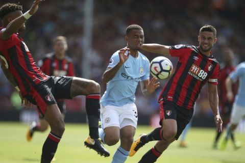 Manchester City's Gabriel Jesus, centre, battles with AFC Bournemouth's Tyrone Mings, left, and Andrew Surman during the English Premier League match, Bournemouth versus Manchester City, at the Vitality Stadium, Bournemouth, England, Saturday Aug. 26, 2017. (Steven Paston/PA via AP)