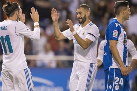 Real Madrid's Gareth Bale, left, celebrates with Real Madrid's Karim Benzema after scoring the opening goal agains Deportivo during a Spanish La Liga soccer match between Deportivo and Real Madrid at the Riazor stadium in Coruna, Spain, Sunday, Aug. 20, 2017. (AP Photo/Lalo R. Villar)