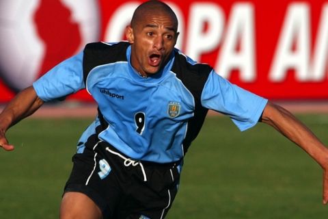**FILE** Uruguay's Dario Silva celebrates after scoring a goal against Paraguay during a quater final game of the Copa America in Tacna, southern Peru in this July 18, 2004 file photo. Doctors amputated the shattered right leg of Uruguayan national team forward Dario Silva after he was thrown from his car in a weekend automobile accident, hospital authorities said Monday, Sept. 25, 2006. Police said the 33-year-old Silva was driving along a Montevideo highway called the "Rambla" that fronts the River Plate Estuary in the Uruguayan capital early Sunday when his vehicle struck a lightpost on a center divider. (AP Photo/Dario Lopez-Mills)