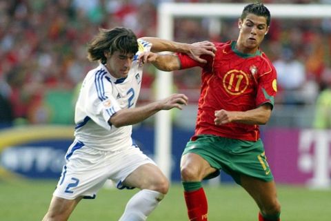 epa000226578 Portugal's Cristiano Ronaldo(R) fights for the ball with Greek Giourkas Seitaridis during  the EURO 2004 Final between  Portugal and Greece at Luz stadium in Lisbon on Sunday 04 July 2004.  EPA/PAULO CARRICO NO MOBIL APPLICATIONS