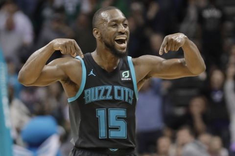 Charlotte Hornets' Kemba Walker (15) reacts after a basket against the Boston Celtics during the second half of an NBA basketball game in Charlotte, N.C., Monday, Nov. 19, 2018. (AP Photo/Chuck Burton)