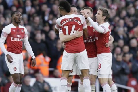 Arsenal players celebrate after Arsenal's Granit Xhaka scored his side's opening goal during the English Premier League soccer match between Arsenal and Manchester United at the Emirates Stadium in London, Sunday, March 10, 2019. (AP Photo/Tim Ireland)