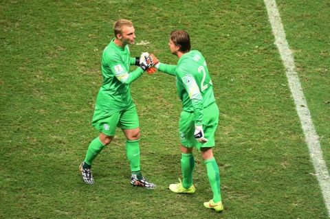 SALVADOR, BRAZIL - JULY 05: Tim Krul of the Netherlands shakes hands with Jasper Cillessen as he enters the game during the 2014 FIFA World Cup Brazil Quarter Final match between the Netherlands and Costa Rica at Arena Fonte Nova on July 5, 2014 in Salvador, Brazil.  (Photo by Laurence Griffiths/Getty Images)