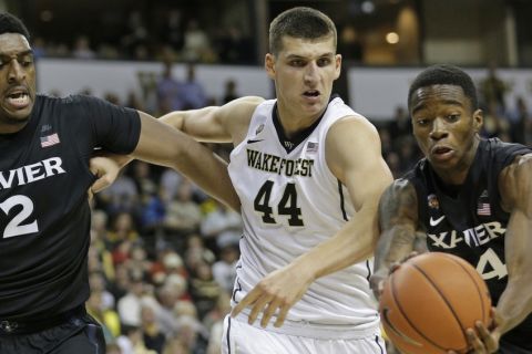 Wake Forest's Konstantinos Mitoglou (44) chases a loose ball with Xavier's Edmond Sumner (4) and James Farr (2) the first half of an NCAA college basketball game in Winston-Salem, N.C., Tuesday, Dec. 22, 2015. (AP Photo/Chuck Burton)