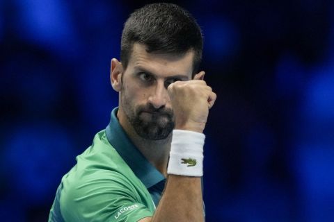 Serbia's Novak Djokovic reacts after winning a point to Italy's Jannik Sinner during their singles final tennis match of the ATP World Tour Finals at the Pala Alpitour, in Turin, Italy, Sunday, Nov. 19, 2023. (AP Photo/Antonio Calanni)