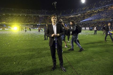 Boca Juniors coach Guillermo Barros Schelotto stands still on the field for  video filming crew after his team defeated Union de Santa Fe 2-1 in Buenos Aires, Argentina, Sunday, June 25, 2017. (AP Photo/Agustin Marcarian).
